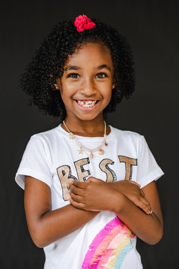Young girl holding her arms during Alameda School Portraits