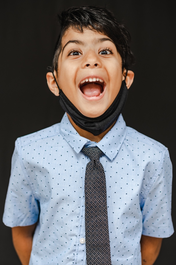 Young boy posing for school photos in Oakland, CA