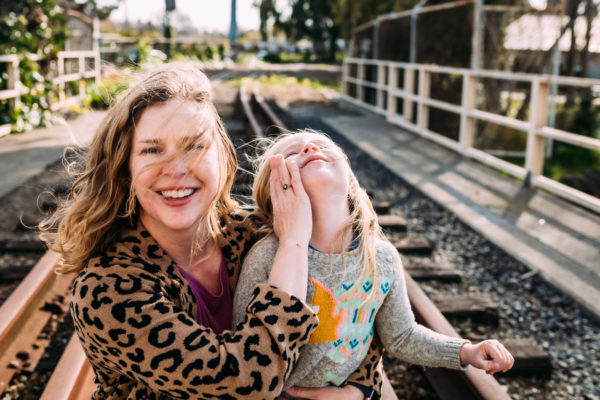 A mother holds her daughters face in Alameda, CA