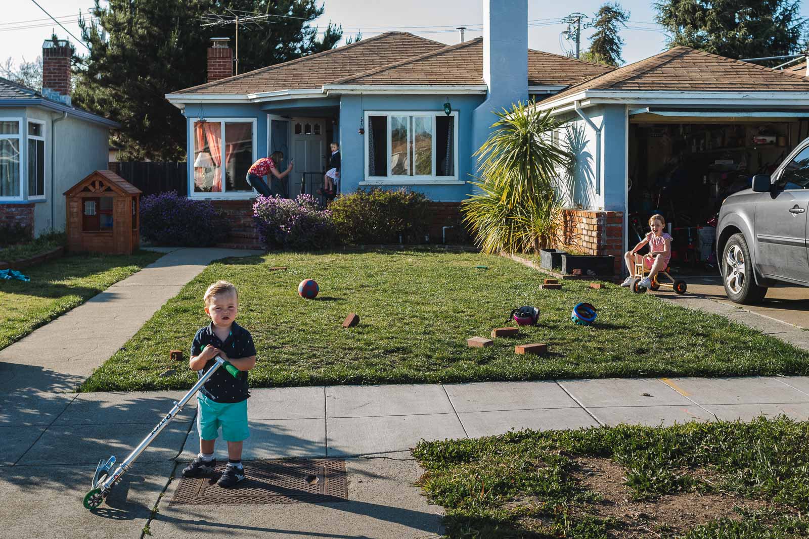 A family stands in front of their home in Alameda, CA