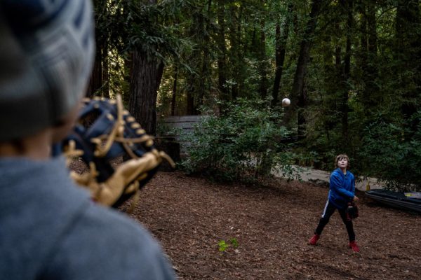 Two boys play catch while camping at Ventana Campground in Big Sur, CA