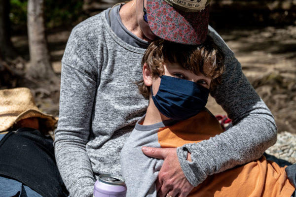 A mom cradles her son at Julia Pfeiffer State Park in Bug Sur, Ca