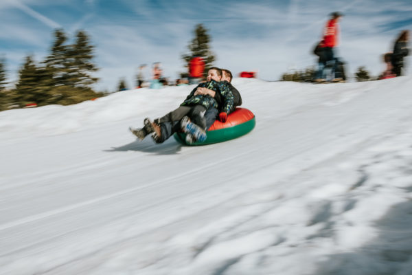 A father and son slide down a tubing hill in Lake Tahoe, CA