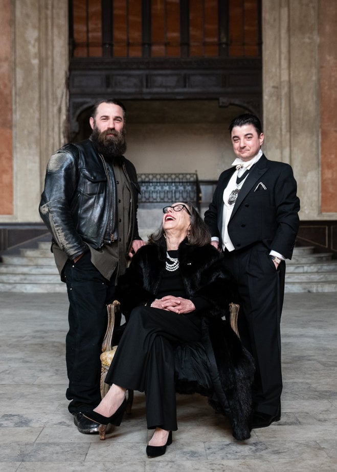 Mother and sons sit in formal attire for a portrait at the 16th St Bart Station in Oakland, CA