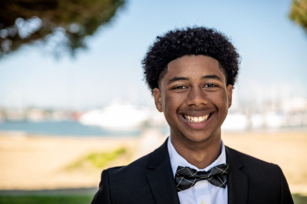 A teen boy poses in during a senior photography session in Richmond, CA